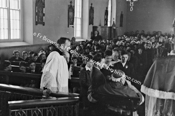 BISHOP EXAMINING CHILDREN